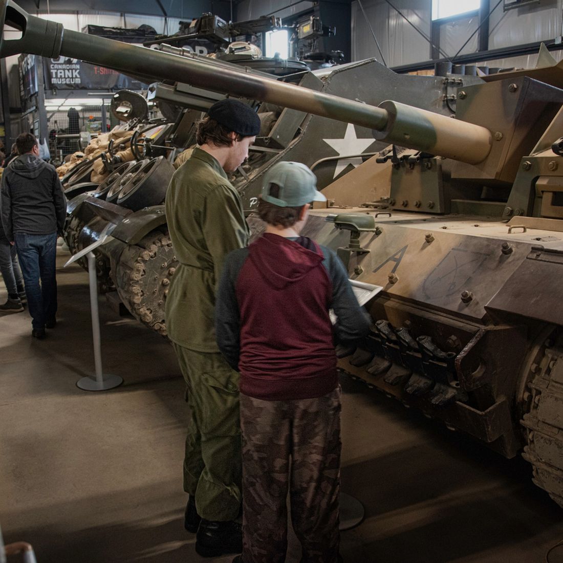 Visitors exploring a vehicle at the Canadian Tank Museum